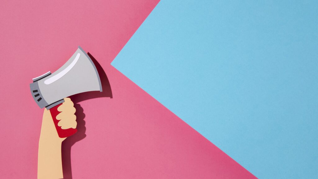 top-view-paper-hand-holding-megaphone
